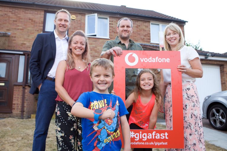 Photo of Vodafone UK’s Neil Blagden, Chief Operating Officer (far left) and Kate Wright, Head of Consumer and Innovation, (far right) with the first Vodafone Gigafast Broadband family in Milton Keynes. Parents Micaela and Chris are now receiving close to gigabit speed (1,000 Mbps) with Vodafone. Their two children Daisy and Harry are wearing Vodafone’s new V-Kids Watch.