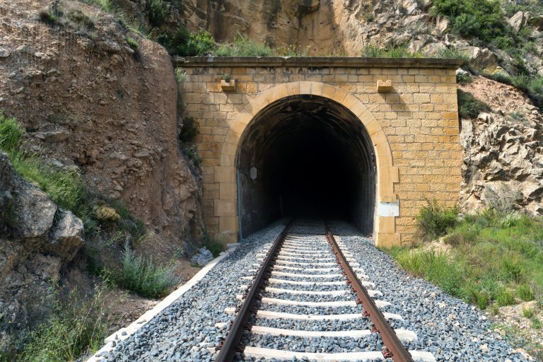 Train track going into tunnel
