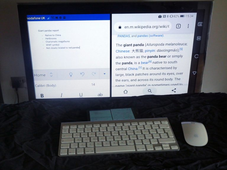 Photo of an Android phone casting apps to a TV while connected to a Bluetooth keyboard and mouse