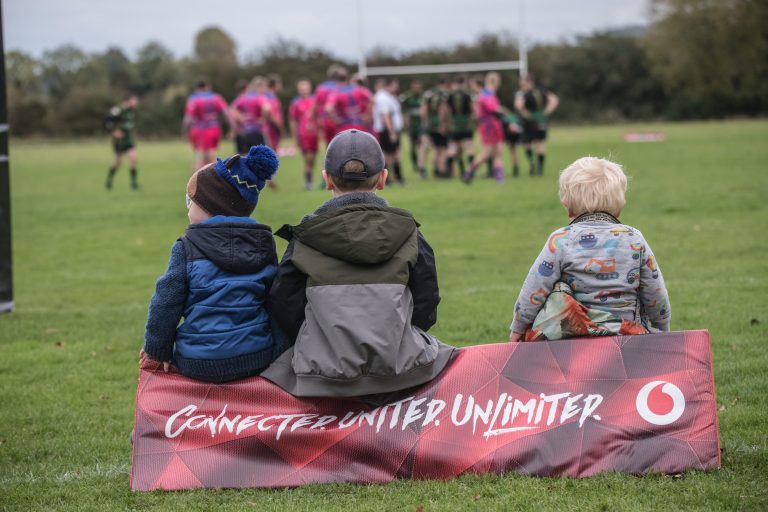 illustrative photo of children watching a walking rugby game