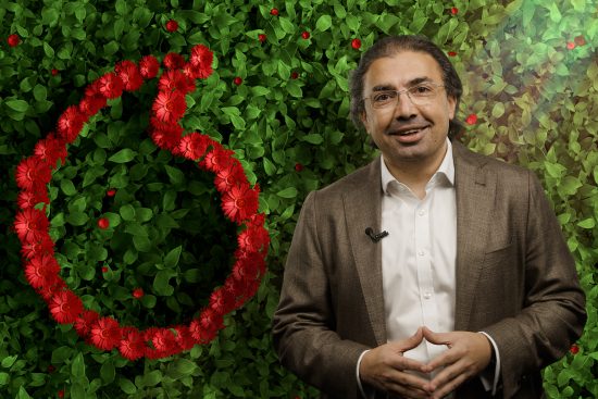 Image of Ahmed, CEO, Vodafone UK in front of a green wall with Vodafone speechmark.