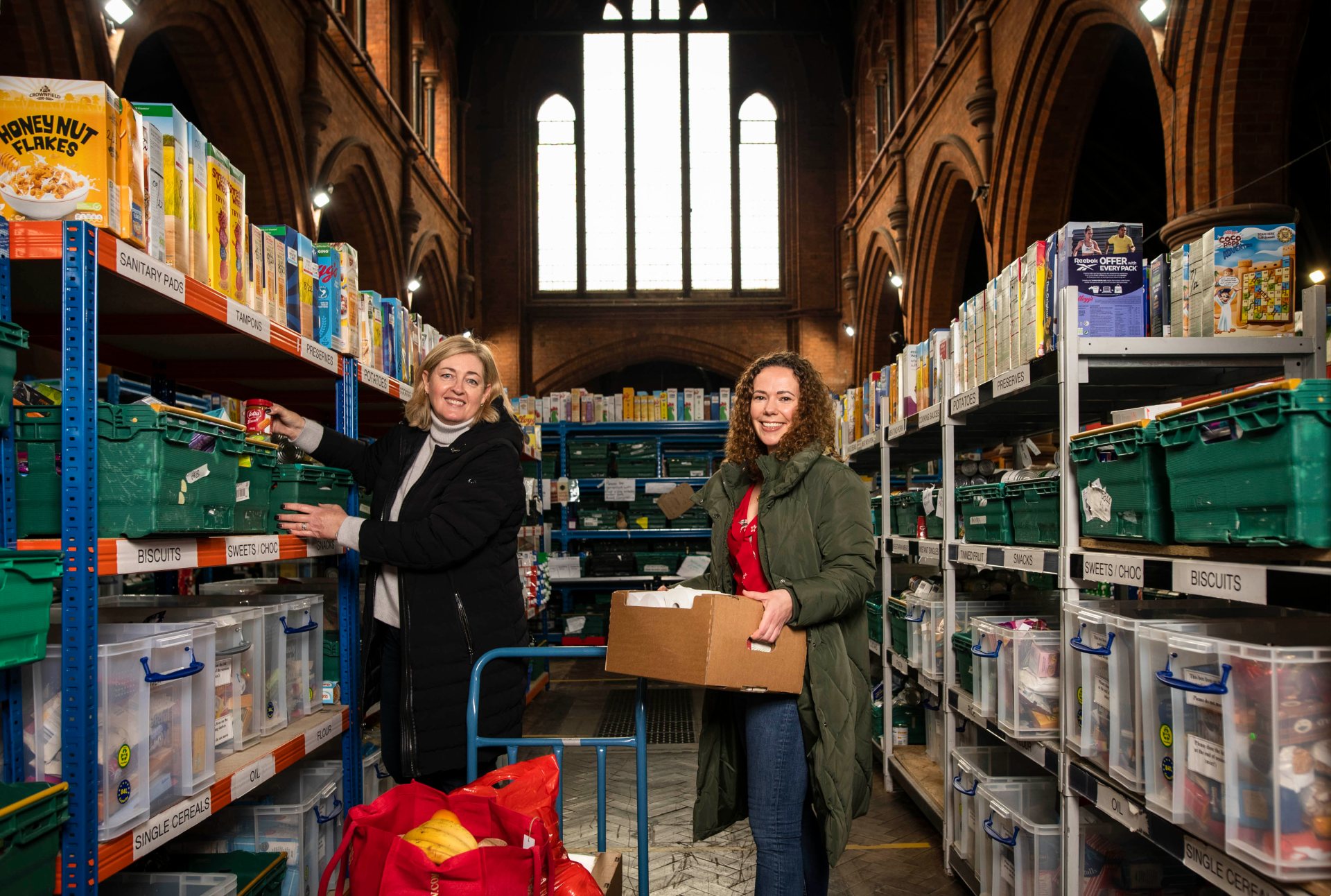 The Trussell Trust's Angela Miller (left) and Vodafone's Rachel Evans helping out at a London food bank