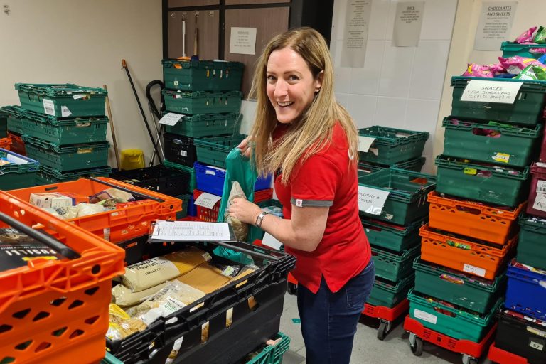 Nicki Lyons, Vodafone's UK Director of Corporate Affairs & Sustainability, packs food parcels ready for distribution